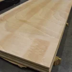 Full view of a 2500x1250 mm ceiba veneered blockboard sheet lying on a warehouse pallet.