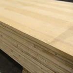 Detailed view of the inner wood block core layers in a stack of veneered blockboards.