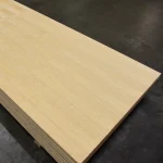 Stack of 2500x1250 mm veneered blockboards stored in a warehouse.