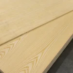 Detailed view of the smooth surface and natural wood pattern of white ash veneer on blockboard.