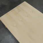 Diagonal view of a large white ash veneered blockboard panel.