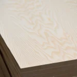 Close-up of the corner of a 19mm blockboard showing the veneer edge and core structure.