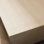 Angled view of the top sheet of white ash veneered blockboard in a stack.