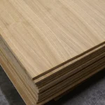 Corner view of a stack of oak veneered blockboards, highlighting the thickness and layered construction.