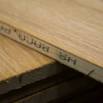 Close-up of the edge of the oak veneered blockboard showing the inner core structure and marking.