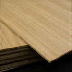 Stacked oak veneered blockboards with one panel shifted to display the edge marking and surface quality.
