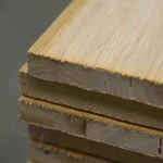 Close-up of the edge of stacked oak veneered blockboards, showing the inner core structure.