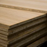 Stacked oak veneered blockboards with one sheet offset to show the edge profile.