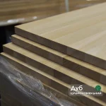 Stacked solid-lamella oak furniture panels with a text label.