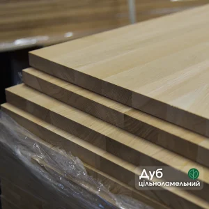 Stacked solid-lamella oak furniture panels with a text label.