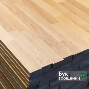 Close-up of a stack of finger-jointed beech furniture panels showing the jointed wood texture.