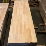 Top view of a long finger-jointed beech furniture panel highlighting its uniform surface.