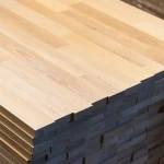Corner view of stacked finger-jointed beech panels showing the precise wood joints.