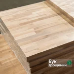Stack of finger-jointed beech furniture boards with a natural wood texture.
