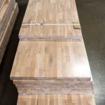 Top view of packaged finger-jointed beech panels stacked in a warehouse.