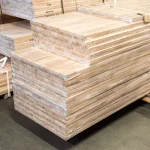 Large stack of protective-wrapped beech furniture boards ready for shipment.