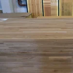 Stack of finger-jointed oak panels showcasing the characteristic block pattern on the wood surface.