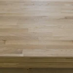 Smoothly sanded surface of a 1st grade finger-jointed oak furniture board.