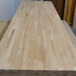 Perspective view of a 3-meter long finger-jointed oak furniture board.