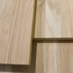 Close-up of overlapping finger-jointed oak panels highlighting the natural wood grain and joints.