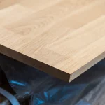 Detailed view of the finished corner and edge of the oak furniture board.