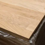 Corner detail of a stacked finger-jointed oak furniture board showing its 20 mm thickness.