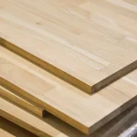 Stacked oak furniture boards showing the clean cut edges and smooth surfaces.