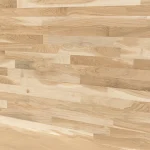 Surface texture of a finger-jointed oak furniture panel showing natural wood grain.