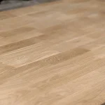 Smooth sanded surface of a finger-jointed oak panel close-up.