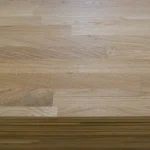 Detailed texture of the finger-jointed oak panel surface with a shallow depth of field.