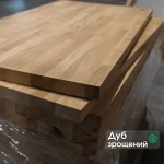Stacked finger-jointed oak furniture boards with a descriptive text label.