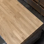 Top view of the smooth, sanded surface of a Grade 1 finger-jointed oak board.