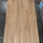 Full top-down view of a 1.3 m long finger-jointed oak furniture board.