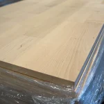 Close-up of the corner and edge of the 20mm thick finger-jointed alder board, showing the clean cut.