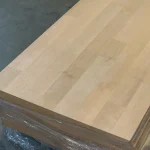 Stack of finger-jointed alder furniture panels wrapped in protective film.