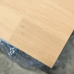 Close-up of the corner of a finely sanded finger-jointed alder board.