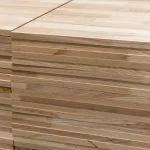 Side view of stacked ash panels highlighting the precise finger-jointing connection on the edges.