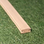General view of the ash H-profile for wooden grilles on a green background