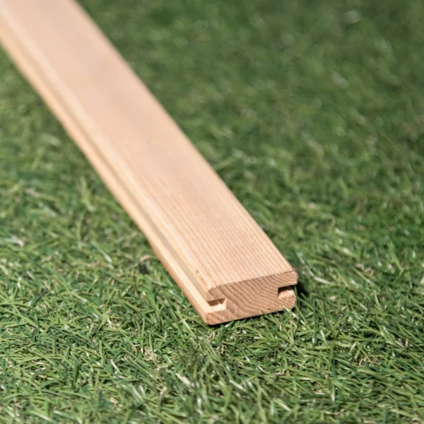 General view of the ash H-profile for wooden grilles on a green background