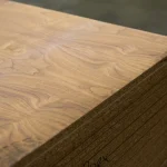 Corner of chipboard sheet faced with sawn American Walnut veneer