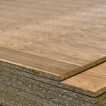 Edges of stacked veneered chipboard sheets close-up
