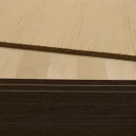 Stack of veneered chipboard sheets in warehouse