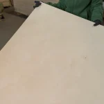 Handling a sheet of FC birch plywood in the warehouse