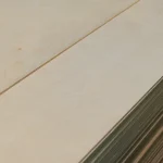 Surface and edge of FC plywood sheets 6 mm 1525x1525 mm in a bundle.
