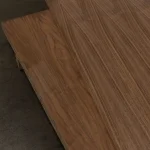 Sheets of American walnut veneered plywood stacked in a warehouse.