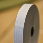 Close-up of perforation pattern on white gummed veneer tape