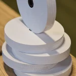 Stacked rolls of white 20 mm gummed tape for veneer splicing