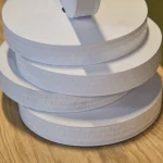 Side view of white perforated gummed tape rolls, 200 m winding
