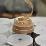 Three rolls of 20 mm perforated gummed tape stacked on top of each other