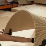 Arch-bent flexible MDF board in master's hands